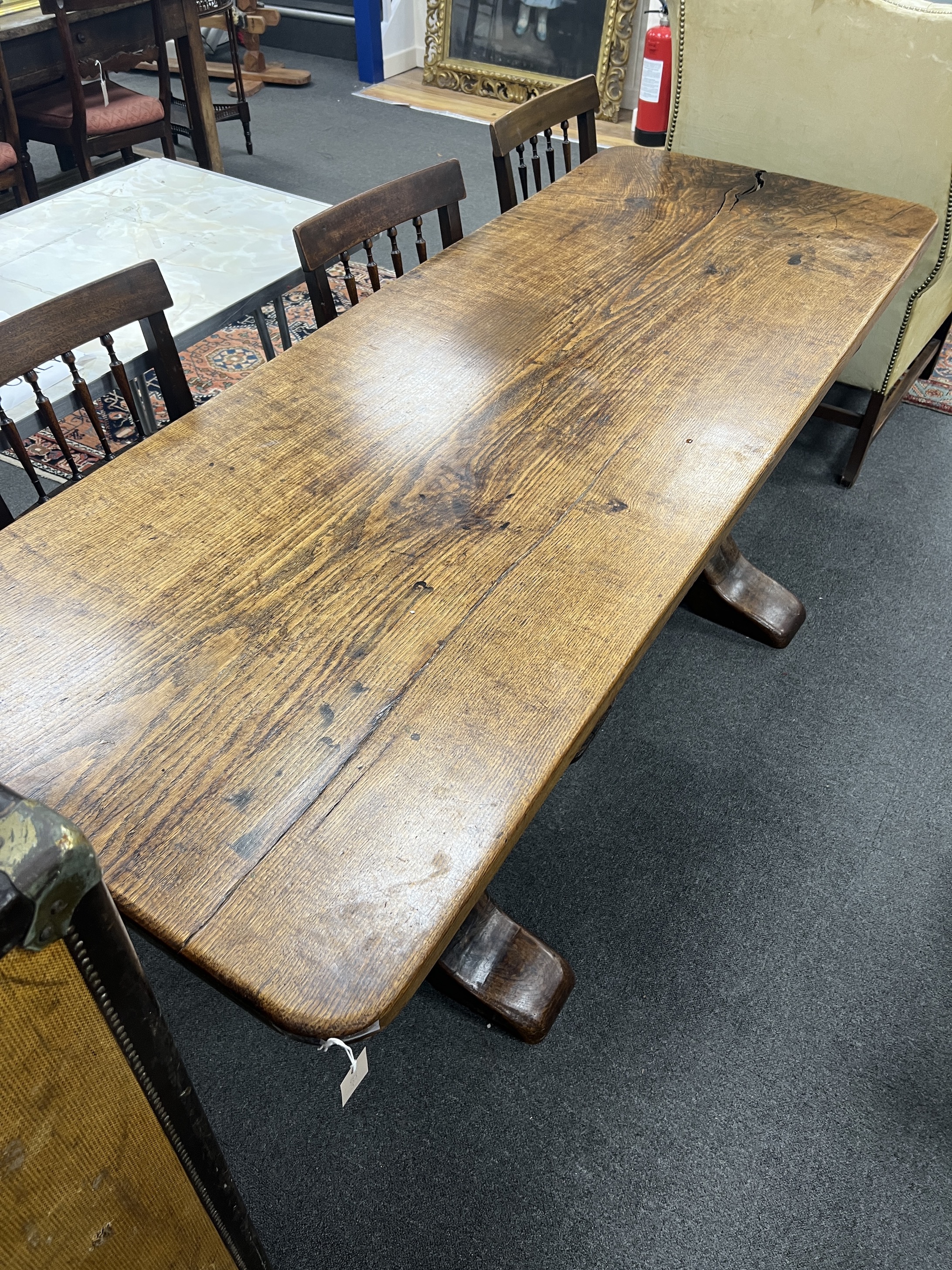 An 18th century style rectangular oak refectory table with single plank top on square end standards, length 194cm, depth 74cm, height 78cm